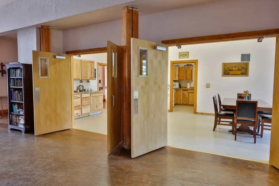 Round table with folding chairs in a carpeted room