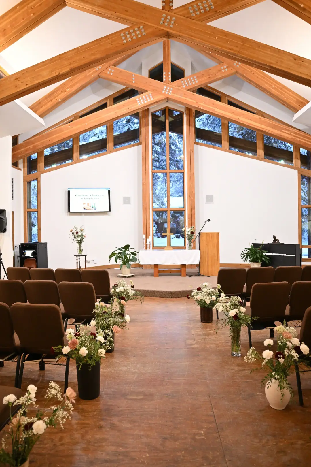 Sanctuary looking toward the windows, with a piano in the foreground